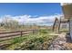 Backyard featuring a wooden fence, a small patio, and scenic views of trees and sky at 5335 S Lisbon Way, Centennial, CO 80015