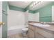 Well-lit bathroom featuring a shower, tub, and vanity with ample counter space at 5335 S Lisbon Way, Centennial, CO 80015