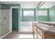 Bright bathroom featuring a shower, soaking tub, and vanity with ample counter space at 5335 S Lisbon Way, Centennial, CO 80015