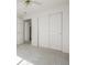Well-lit bedroom featuring a closet, doorway, and carpeted floor at 5335 S Lisbon Way, Centennial, CO 80015