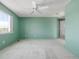 Comfortable bedroom featuring a ceiling fan and large window for ample natural light at 5335 S Lisbon Way, Centennial, CO 80015