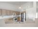 Open kitchen featuring stainless steel appliances and bright white countertops at 5335 S Lisbon Way, Centennial, CO 80015