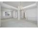Bright, spacious living room with neutral carpet and a chandelier at 5335 S Lisbon Way, Centennial, CO 80015