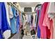 Walk-in closet providing ample storage with clothes hanging on racks, shelves with boxes, and suitcases at 6650 E Arizona Ave # 163, Denver, CO 80224