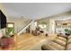 Bright living room features hardwood floors, and a staircase leading to the upper level at 6650 E Arizona Ave # 163, Denver, CO 80224