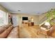 Cozy living room with hardwood floors, a modern TV, and a welcoming front door at 6650 E Arizona Ave # 163, Denver, CO 80224