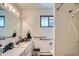 Clean bathroom with white tile walls, accessible grab bars, and updated fixtures at 4465 Cody St, Wheat Ridge, CO 80033