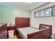 Bedroom featuring wood floors, a large wood headboard, a large dresser, and a window at 4465 Cody St, Wheat Ridge, CO 80033