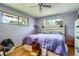 Bedroom featuring light purple walls, hardwood floors, and two windows for natural light at 4465 Cody St, Wheat Ridge, CO 80033