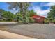 Charming brick home with mature landscaping and a spacious gravel yard at 4465 Cody St, Wheat Ridge, CO 80033