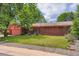 Charming brick home featuring a well-maintained lawn and a lovely covered porch at 4465 Cody St, Wheat Ridge, CO 80033