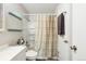 This bathroom features a shower, sink, toilet and mirrored medicine cabinet at 11228 W 18Th Ave, Lakewood, CO 80215