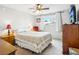 Comfortable bedroom featuring a ceiling fan, window with curtains and vintage dresser at 11228 W 18Th Ave, Lakewood, CO 80215