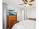 Comfortable bedroom featuring a ceiling fan, TV on dresser, and ensuite bathroom at 11228 W 18Th Ave, Lakewood, CO 80215