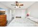 Comfortable bedroom with ceiling fan, ensuite bathroom and gray walls at 11228 W 18Th Ave, Lakewood, CO 80215