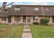Charming townhouse with brick facade, well-maintained lawn, and inviting entryway creates a warm welcome at 11228 W 18Th Ave, Lakewood, CO 80215