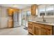 Bright kitchen featuring stainless steel refrigerator, wooden cabinets, and tile floors at 11228 W 18Th Ave, Lakewood, CO 80215