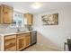 Bright kitchen featuring stainless steel appliances, wooden cabinets, and tile floors at 11228 W 18Th Ave, Lakewood, CO 80215