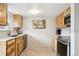Bright kitchen featuring stainless steel appliances, wooden cabinets and tile floors at 11228 W 18Th Ave, Lakewood, CO 80215
