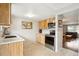 Bright kitchen with wooden cabinets, stainless steel appliances and tile backsplash at 11228 W 18Th Ave, Lakewood, CO 80215