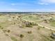 Aerial view of a home surrounded by a dirt road, on an expansive lot in a rural community at 1559 Lisbon Dr, Parker, CO 80138