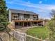 Back exterior showcasing a hot tub and outdoor seating area with a partially fenced yard at 1559 Lisbon Dr, Parker, CO 80138
