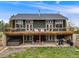 Spacious back exterior featuring a deck, hot tub, and patio with comfortable outdoor seating at 1559 Lisbon Dr, Parker, CO 80138