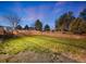 Green backyard with brick retaining wall, well-maintained lawn, and ample space at 1559 Lisbon Dr, Parker, CO 80138