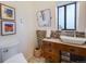 Bathroom with modern sink, beautiful backsplash, and storage at 1559 Lisbon Dr, Parker, CO 80138