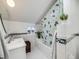 Bathroom with white tiles, a vanity, a bathtub with shower curtain, and a window at 1559 Lisbon Dr, Parker, CO 80138