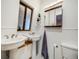 Bathroom features double sinks, white wainscoting, and natural light at 1559 Lisbon Dr, Parker, CO 80138