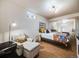 Cozy bedroom with a comfortable seating area and a large window for natural light at 1559 Lisbon Dr, Parker, CO 80138