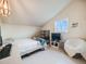 Bedroom with sloped ceiling, comfortable bed, and view of the outside at 1559 Lisbon Dr, Parker, CO 80138