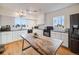 Bright kitchen with white cabinets, stainless steel appliances, and large wood island at 1559 Lisbon Dr, Parker, CO 80138