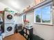 Efficient laundry room with front-load washer and dryer, storage shelves, and a view from the window at 1559 Lisbon Dr, Parker, CO 80138