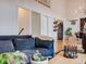 Cozy living room features a comfortable blue couch and flows into the kitchen and dining areas at 1559 Lisbon Dr, Parker, CO 80138