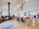 Open-concept living space with a dining table, wood stove, and plenty of natural light from the surrounding windows at 1559 Lisbon Dr, Parker, CO 80138