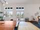 Bright living room with hardwood floors, dining table, and large windows offering plenty of natural light at 1559 Lisbon Dr, Parker, CO 80138