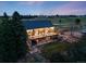 Rear view of the house, featuring a wooden deck, hot tub, patio area, and landscaped yard with views of the countryside at 1559 Lisbon Dr, Parker, CO 80138