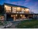 Rear of the house, highlighting the deck, lower level patio with seating, grill, hot tub, and outdoor space at 1559 Lisbon Dr, Parker, CO 80138