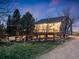 Exterior view of the rear of the home showcasing the wooden deck, outdoor space, and surrounding greenery at 1559 Lisbon Dr, Parker, CO 80138