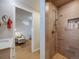 Shower with wooden tiles, a handheld shower head, and built-in shelving with soaps at 1559 Lisbon Dr, Parker, CO 80138
