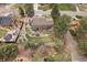 Aerial view of a brown two-story home highlighting its well-maintained lawn, mature trees and landscaping at 8015 Lt William Clark Rd, Parker, CO 80134