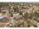 Aerial view features a two-story home surrounded by lush landscaping and mature trees in a desirable neighborhood at 8015 Lt William Clark Rd, Parker, CO 80134