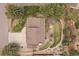 Aerial view displays a well-maintained property with a large patio, green lawn, and mature trees at 8015 Lt William Clark Rd, Parker, CO 80134
