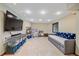 Well-lit finished basement featuring a large TV, ample storage, and comfortable seating at 8015 Lt William Clark Rd, Parker, CO 80134