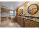 Bright bathroom with double sinks, granite countertops, walk in shower, tub and nice cabinets at 8015 Lt William Clark Rd, Parker, CO 80134