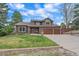 Inviting home featuring a three-car garage, stone accents, and a well-maintained front lawn at 8015 Lt William Clark Rd, Parker, CO 80134