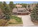 Charming two-story home with a three-car garage, well-manicured lawn, mature trees, and a welcoming exterior at 8015 Lt William Clark Rd, Parker, CO 80134