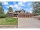 Charming two-story home with a three-car garage, well-manicured lawn, and an inviting front entrance at 8015 Lt William Clark Rd, Parker, CO 80134